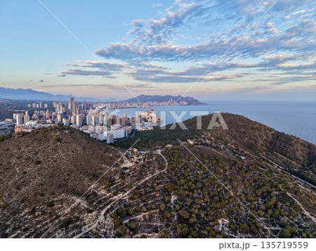 morning trail with ocean view, outdoor adventure along winding path overlooking city and sea at dawn morning trail with ocean view, outdoor adventure along winding path overlooking city and sea at dawn 135719559