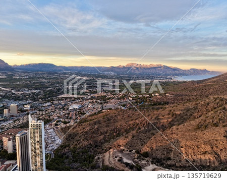 urban coastline with skyscrapers view, seaside urban panorama showing highrise buildings and mountains urban coastline with skyscrapers view, seaside urban panorama showing highrise buildings and mountains 135719629