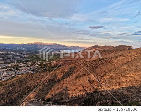 bright ridge with expansive vistas, majestic rocky slopes under radiant sunlight with panoramic views 135719630
