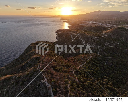 sea cliffs panorama, dramatic coastline with sunset, vivid ocean scene with silhouettes and reflections sea cliffs panorama, dramatic coastline with sunset, vivid ocean scene with silhouettes and reflections 135719654