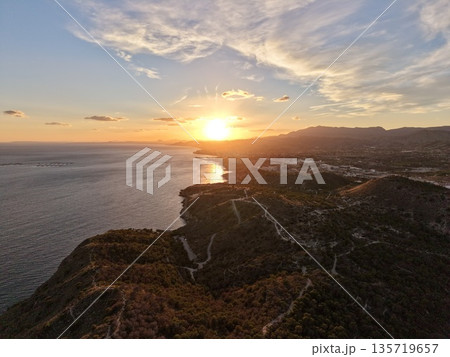 calm sunset along winding coast, serene seaside panorama featuring gentle clouds and extended coastlines calm sunset along winding coast, serene seaside panorama featuring gentle clouds and extended coastlines 135719657