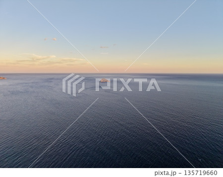 quiet isle at dawn surrounded, untouched island during sunrise amidst tranquil sea surroundings 135719660