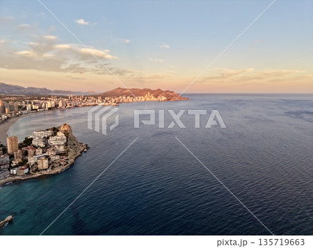 sunsetlit beach and calm water, golden sunset casting warm light over tranquil shoreline bay sunsetlit beach and calm water, golden sunset casting warm light over tranquil shoreline bay 135719663