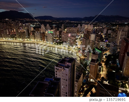 urban night view, spectacular view of illuminated skyscrapers and coastal reflections after dark urban night view, spectacular view of illuminated skyscrapers and coastal reflections after dark 135719691