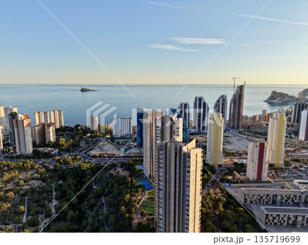 coastal metropolis under blue sky, seaside urban area with busy port activity and maritime ambiance coastal metropolis under blue sky, seaside urban area with busy port activity and maritime ambiance 135719699