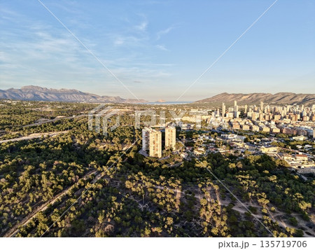 cityscape at sunset, vast aerial perspective capturing urban expansion towards sea during sunset hours 135719706