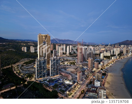 twilight seaside skyline, calm waterfront scene with vibrant evening illumination and distant hills twilight seaside skyline, calm waterfront scene with vibrant evening illumination and distant hills 135719708