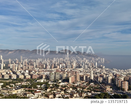 vibrant village with terracotta roofs offering sweeping coastal and mountain perspectives during peaceful days vibrant village with terracotta roofs offering sweeping coastal and mountain perspectives during peaceful days 135719715