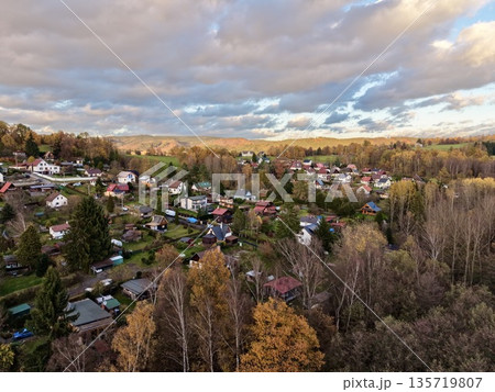 leafy outskirts with welcoming dwellings, peaceful neighborhood filled with colorful fall foliage leafy outskirts with welcoming dwellings, peaceful neighborhood filled with colorful fall foliage 135719807