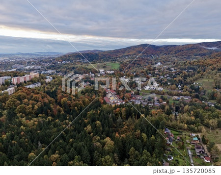 rustic hillside landscape, peaceful hillside settlement amid rolling hills and distant metropolis 135720085