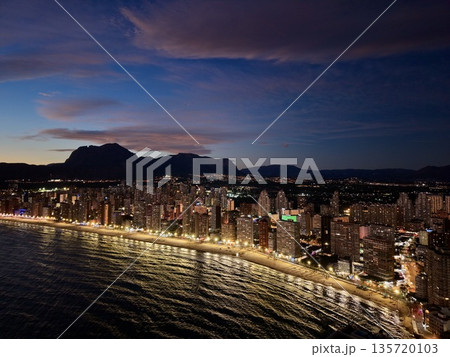 warm evening scenes by tranquil coastlines, serene sunset over hills and peaceful seaside promenade 135720103