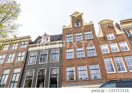Canal Houses facade of Amsterdam City in Netherlands street building architecture. 135721318