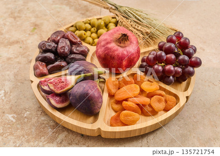 Seven species platter showing traditional israeli harvest fruits Seven species platter showing traditional israeli harvest fruits 135721754
