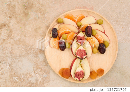 Healthy fruit platter arranging ingredients in palm tree shape 135721795