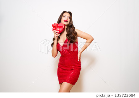 Young woman with a heart shaped gift box 135722084