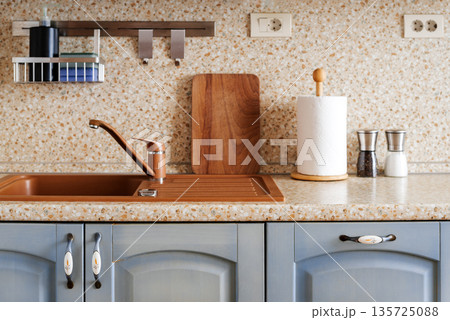 Clean kitchen sink and countertop with wooden board and accessories 135725088