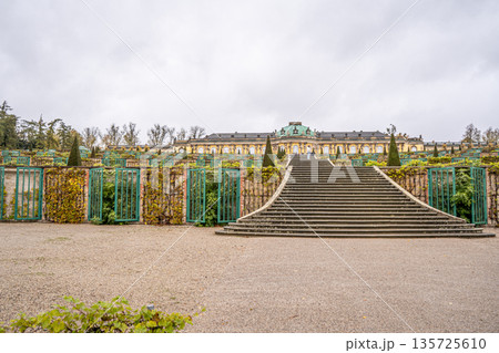 Sanssouci Palace Gardens with Grand Staircase in Potsdam, Germany. Old building architecture in Rococo style garden Sanssouci Palace Gardens with Grand Staircase in Potsdam, Germany. Old building architecture in Rococo style garden 135725610