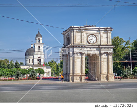 Chisinau, Moldova - September 24, 2025 Triumphal Arch as popular historical landmark of the capital with the Metropolitan Cathedral Nativity of the Lord and the bell tower in the background 135726028