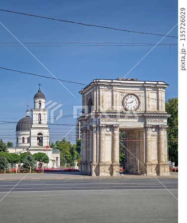 Chisinau, Moldova - September 24, 2025 Triumphal Arch as popular historical landmark of the capital with the Metropolitan Cathedral Nativity of the Lord and the bell tower in the background 135726029
