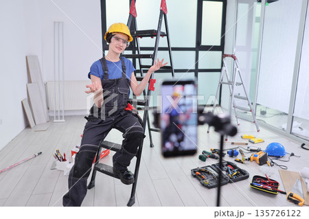 Skilled worker shares expert tips while taking a break in a bright, modern workspace filled with tools Skilled worker shares expert tips while taking a break in a bright, modern workspace filled with tools 135726122