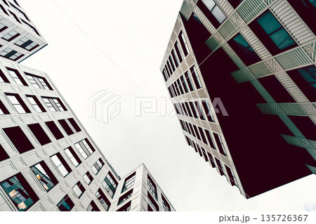 High-rise buildings of modern city. View from below. High-rise buildings of modern city. View from below. 135726367