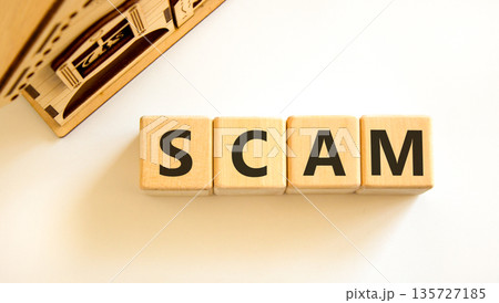 Scam symbol. Concept word Scam on beautiful wooden blocks. Beautiful wooden house. Beautiful white table white background. Business, lifestyle, support and scam concept. Copy space. Scam symbol. Concept word Scam on beautiful wooden blocks. Beautiful wooden house. Beautiful white table white background. Business, lifestyle, support and scam concept. Copy space. 135727185