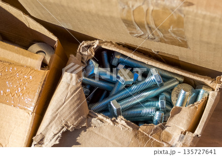 Cardboard Boxes with Open Box Containing Metal Screws Cardboard Boxes with Open Box Containing Metal Screws 135727641
