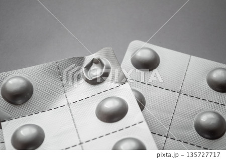 Used aluminum blister pack on a neutral background 135727717