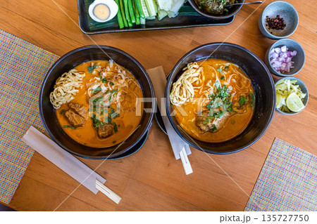 Top view of Northern Thai food Khao Soi, focus selective Top view of Northern Thai food Khao Soi, focus selective 135727750