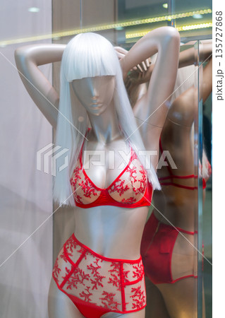 Female mannequin in red lingerie. Showcase lingerie store. 135727868