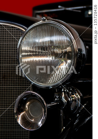The headlight of an antique, rarity, vintage black car. The headlight of an antique, rarity, vintage black car. 135728416