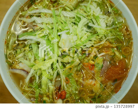 Vietnamese soup tomato noodle fast food chili in a big bowl using spoon or chopstick snapshot photo. Traditional Vietnamese soup that is flavorful comforting nutritious vegetarian savory sweet Vietnamese soup tomato noodle fast food chili in a big bowl using spoon or chopstick snapshot photo. Traditional Vietnamese soup that is flavorful comforting nutritious vegetarian savory sweet 135728997