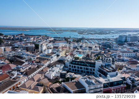 Visitors can enjoy views of the Algarve region from the Old Town of Faro. The Ria Formosa and nearby docks offer a glimpse of local life and activities Visitors can enjoy views of the Algarve region from the Old Town of Faro. The Ria Formosa and nearby docks offer a glimpse of local life and activities 135729039