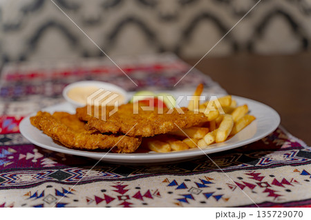 A dish on a plate. A dish on a plate. 135729070