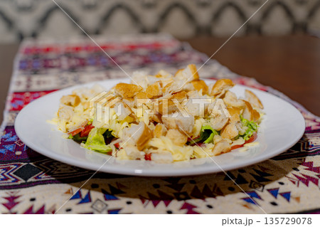 A dish on a plate. A dish on a plate. 135729078
