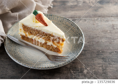 Carrot cake slice with cream cheese frosting Carrot cake slice with cream cheese frosting 135729836