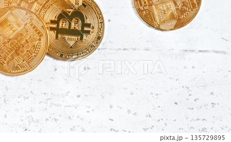 Top down view, golden commemorative btc - bitcoin cryptocurrency - coins on white stone board, closeup detail, space for text down right corner Top down view, golden commemorative btc - bitcoin cryptocurrency - coins on white stone board, closeup detail, space for text down right corner 135729895