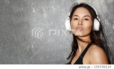 Vietnamese girl in headphones and listen to music in studio with album, podcast, streaming or song. Asian person, playlist and space for audio subscription, hearing hifi sound and radio Vietnamese girl in headphones and listen to music in studio with album, podcast, streaming or song. Asian person, playlist and space for audio subscription, hearing hifi sound and radio 135730114