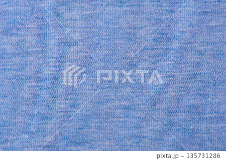 Macro texture of blue colored knitted fabric as a background. Macro texture of blue colored knitted fabric as a background. 135731286