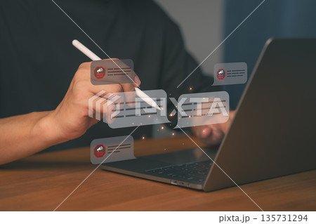 Close-up of hands using a pen on a laptop with floating chat bubbles showing Fake News alerts. Concept for misinformation, digital communication, social media fact-check, and online disinformation. Close-up of hands using a pen on a laptop with floating chat bubbles showing Fake News alerts. Concept for misinformation, digital communication, social media fact-check, and online disinformation. 135731294