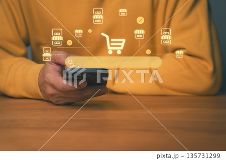 Close-up of person using smartphone with search, shopping cart and store icons, symbolizing mobile e-commerce. Concept for online shopping, digital marketplace, and smart retail business technology. Close-up of person using smartphone with search, shopping cart and store icons, symbolizing mobile e-commerce. Concept for online shopping, digital marketplace, and smart retail business technology. 135731299