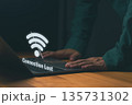 Close-up of person using laptop with Wi-Fi icon and Connection Lost, symbolizing internet disconnection or network failure. Concept for online issues, connectivity problems, or system downtime. 135731302