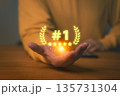 Customer holding glowing number one symbol with five stars, representing success, best quality, customer service, and top performance. Concept of achievement, excellence, and business recognition. 135731304