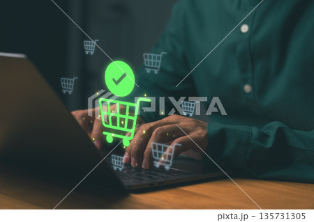 Person using laptop for online shopping with glowing cart icons, representing e-commerce, digital payment, and internet retail. Concept of secure online transaction and modern consumer behavior. Person using laptop for online shopping with glowing cart icons, representing e-commerce, digital payment, and internet retail. Concept of secure online transaction and modern consumer behavior. 135731305