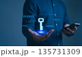 Person holding smartphone with a holographic digital key floating above their hand, symbolizing data encryption, cybersecurity, password protection, and secure access in digital authentication system. 135731309