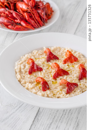 Creamy Italian risotto topped with crawfish tails and olive oil, bright gourmet styling 135731326
