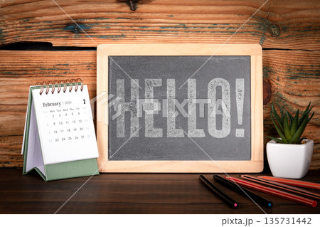 HELLO. Chalkboard Message With Desk Calendar February 2026 On Wooden Workspace 135731442