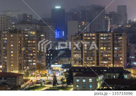 Night panorama of capital city capturing residential architecture, apartment buildings, warm window lights and urban mood, Pristina, Kosovo 135733090