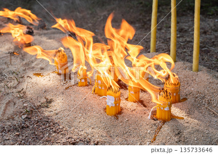 Candles while burning on the ground during Lanna traditional worship ceremony in Northern region of Thailand. In Lanna region of Thailand they believed burning the candle in ceremony to remove bad luc Candles while burning on the ground during Lanna traditional worship ceremony in Northern region of Thailand. In Lanna region of Thailand they believed burning the candle in ceremony to remove bad luc 135733646