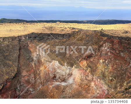 伊豆大島・三原山でトレッキング中に見られる噴気を伴う火口の風景 伊豆大島・三原山でトレッキング中に見られる噴気を伴う火口の風景 135734408